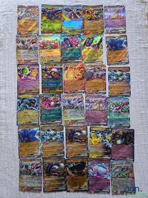 a close up of a pile of pokemon cards on a table