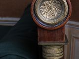 a grandfather clock sitting on top of a wooden pole