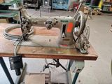 a sewing machine sitting on a table in a workshop