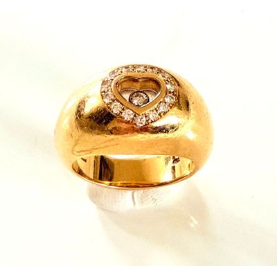 a gold ring with a diamond heart on it