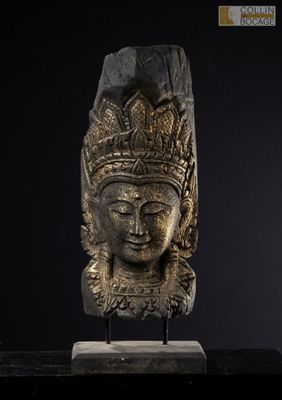 a close up of a statue of a head on a stand