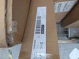a cardboard box with a sticker on it sitting on a table