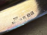 a close up of a silver plate on a wooden table