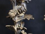 a close up of a metal candle holder on a black background