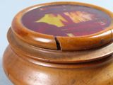 a close up of a wooden box with a picture on it