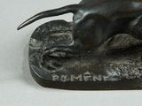statue of a dog on a rock with a sign that says gone and gone