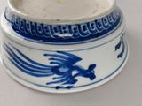 a blue and white vase with a bird on it