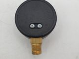 a close up of a black and gold pressurer on a white surface