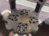 a small table with a metal base on a rug