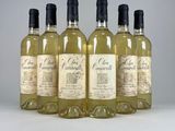 four bottles of white wine are lined up in a row