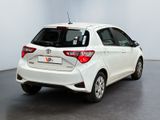 the back of a white toyota yaris parked in a room