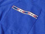 the back of a blue shirt with a red, white, and blue design on it