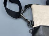 a black and white purse with a black strap