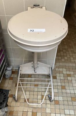 a white toilet sitting in a bathroom next to a trash can