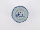 a blue and white plate with a picture of a man and a woman on it