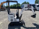 an image of a small excavator parked in a parking lot