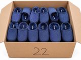 de nombreuses paires de chaussons bleus dans une boîte en carton