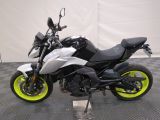 a picture of a white and black motorcycle parked on a checkered floor