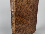 a close up of a book with a brown cover on a white surface