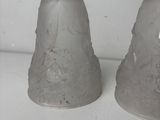 two salt and pepper shakers sitting on a counter