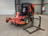 un petit tracteur rouge garé dans un garage