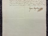 une lettre écrite à l'encre noire sur une feuille de papier