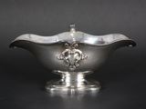 an image of a silver bowl with a lion head on it