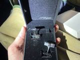 a person holding a pair of cufflinks in a box
