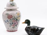 two vases sitting next to each other on a white surface