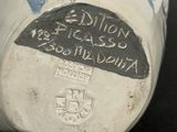 a close up of a white vase with writing on it