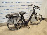 a bike that is parked in front of a wall