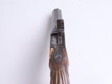 a wooden carving of a woman holding a knife