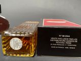 a bottle of perfume sitting next to a box of perfume