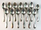 six spoons are lined up in a row on a white surface