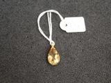 a close up of a necklace on a black surface with a price tag