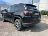 the rear end of a black jeep parked in a parking lot
