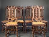 three antique wooden chairs with carved back and seat cushions