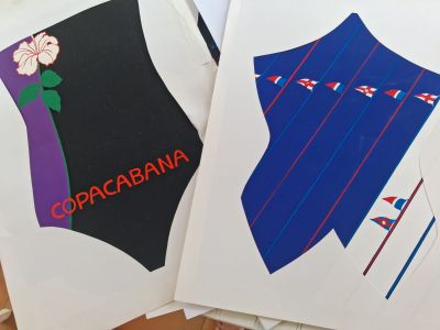 two envelopes with different designs on them sitting on a table
