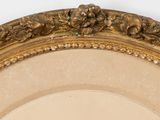 a picture of a gold framed mirror on the wall
