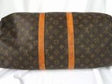 a brown and orange bag sitting on a white surface