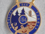 badge of a firefighter ' s badge with a fire hydrant in the background