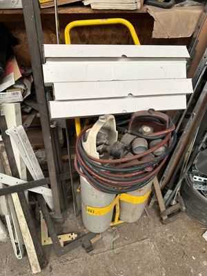 a pile of junk in a garage next to a fire hydrant