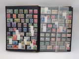 an open book with stamps on it sitting on a table