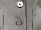 a close up of a jacket with buttons on it