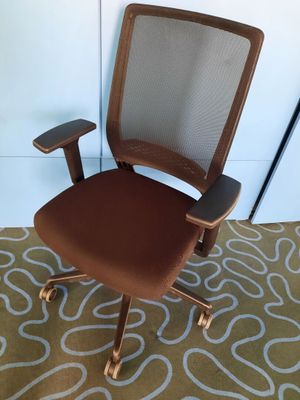 an image of a brown office chair on a rug in a room