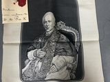 an old picture of a man sitting in a chair with a red wax seal