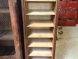 pair of antique wooden bookcases with open shelves in a room