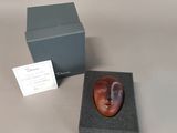 a small box with a face on it and a business card in it
