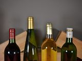 three bottles of wine sitting on a table next to each other