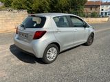 a silver car that is parked on the side of the road